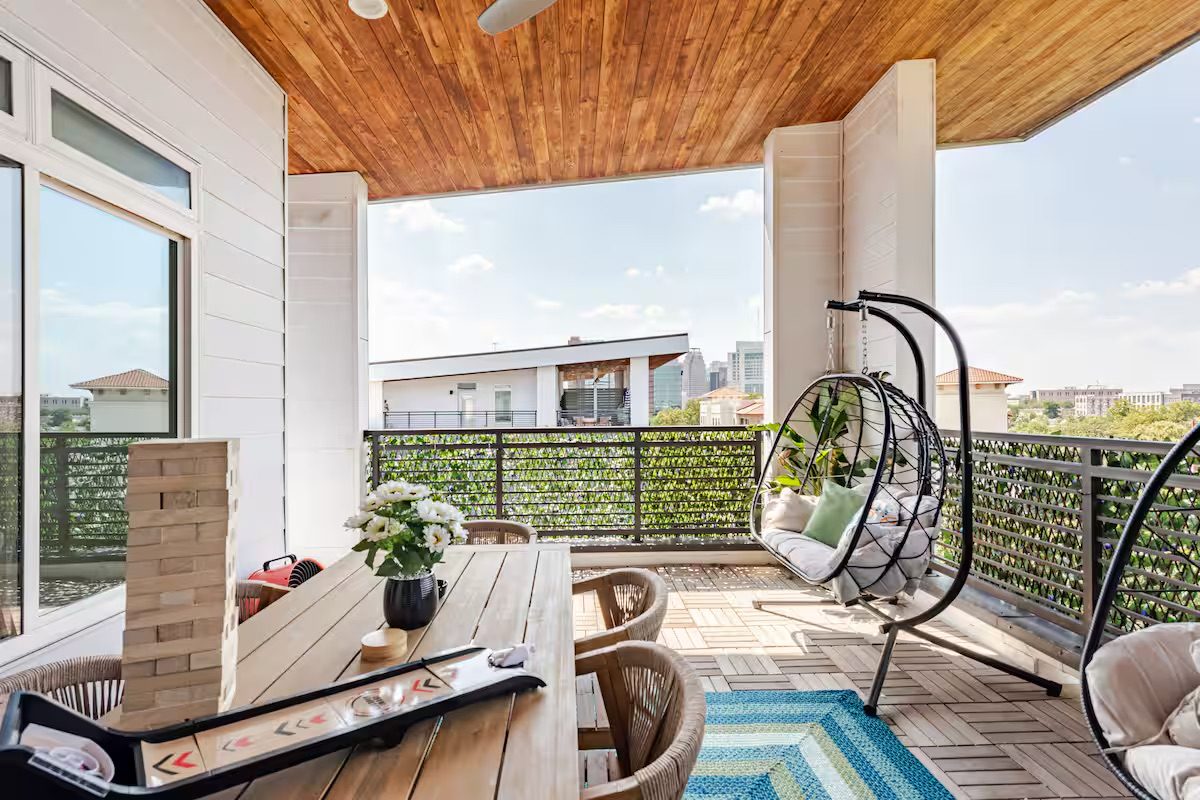 Balcony with hanging chairs and city views